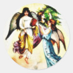 A christmas greetings with three angels with a chr round stickers