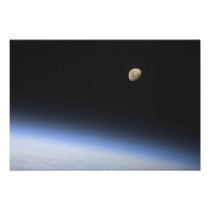 A gibbous moon visible above Earth's atmosphere 2