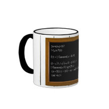A hand writing formula on a chalkboard mugs