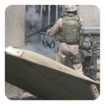 A military policeman uses a breaching round square stickers