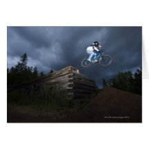 A mountain biker jumps off a log cabin in Idaho. Greeting Cards