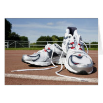 A pair of new white running trainers are placed greeting cards
