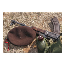 A rifle, military cover and canteen