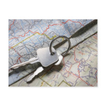 A set of car keys on a pile of road maps. postcard