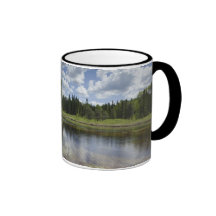 A Still Pond Reflecting The Clouds Mugs