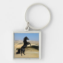 A wild rearing black stallion keychains