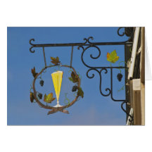 A wrought iron sign that illustrates the theme card