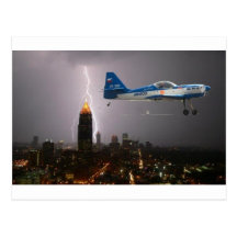 Aerobatic aeroplane in lightning post card