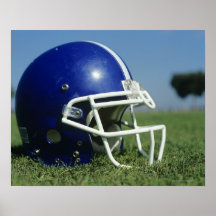 American football helmet in grass,close-up posters