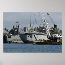 An F-15 Eagle gets a lift from a barge crane Poster
