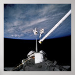 Astronauts conduct spacewalk above Discovery posters