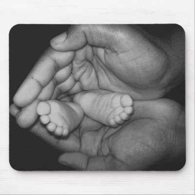 baby feet in father's hands mouse mats by rreid13