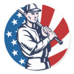 Baseball player holding bat american flag woodcut round sticker