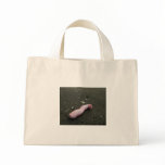 Beach pollution broken doll leg on sand tote bag