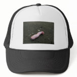 Beach pollution broken doll leg on sand trucker hat