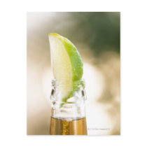 Beer bottle with lime wedge post cards