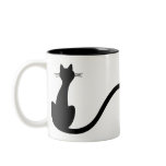 Bird roosting on cat's tail mugs