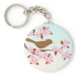 Bird sitting in a cherry blossom tree keychain