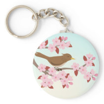 Bird sitting in a cherry blossom tree keychain