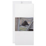 Black alpine goat doe waiting at metal gate rack card