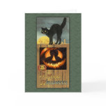 Black cat on a wooden fence with pumpkin greeting cards