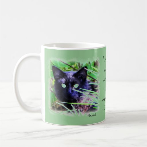 Black cat with striking green eyes coffee mug
