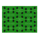 black flowers on green post card