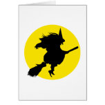 Black witch silhouette against golden full moon card