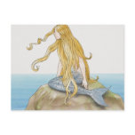 Blonde mermaid sitting on sea rock, side view. post card