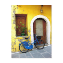 Blue bicycle against a yellow wall post cards