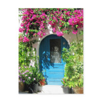 Blue door framed with beautiful bougainvillea postcards