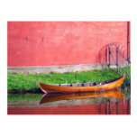 Boat-near-red-round-building BOAT CANOE WATER TRAN Postcard