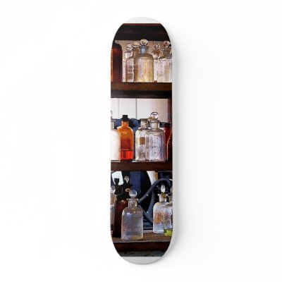 Bottles of Chemicals on Shelves Skate Board by SusanSavad