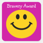 Bravery award yellow smiley face on pink sticker
