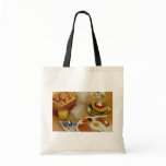 Breakfast of bacon, eggs and pitcher of milk tote bags