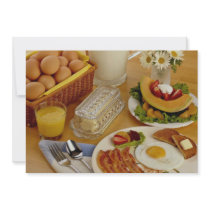 Breakfast of bacon, eggs and pitcher of milk invites