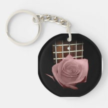 Brownish pink single rose against fretboard