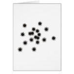 Bullet holes from a rifle or gun, possibly shotgun cards