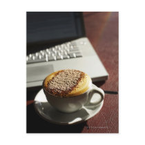 Cappuccino in front of laptop post card