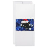 Cat with santa hat looking out from blue tinsel