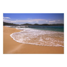 Champagne seas on a deserted island beach photo