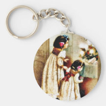 Christmas as two girls looking at decorated christ key chain