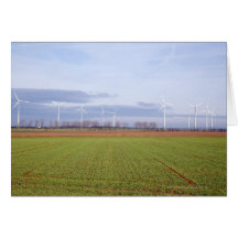 Clean energy by many wind turbines on fields. greeting card
