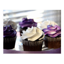 Close-up of cupcakes with selective focus on post card