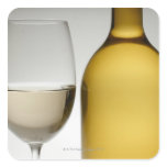 Close up of glass of white wine and wine bottle sticker