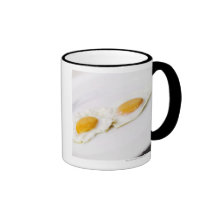 Close-up of two fried eggs mugs