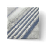 Close-up on a tyre traces in the snow buttons