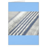 Close-up on a tyre traces in the snow cards