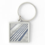 Close-up on a tyre traces in the snow keychains