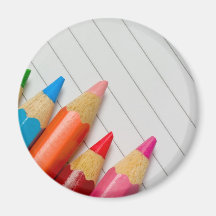 Colour pencils on a notepad fridge magnets